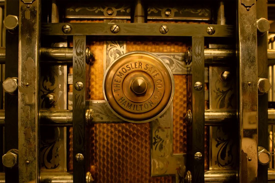 A close-up of a heavy safe door with its lock