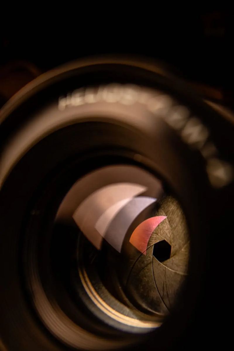 A macro of a camera lens aperture, its blades forming the iris