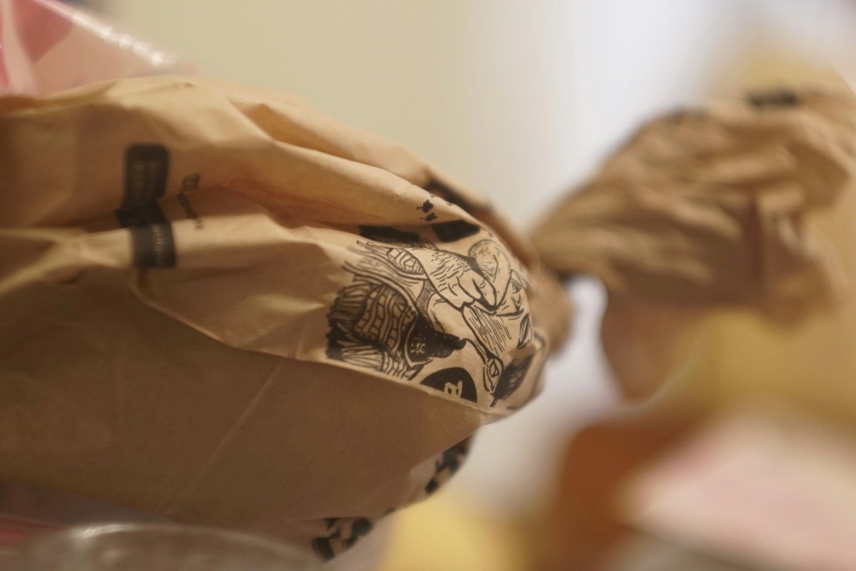 Brown paper packages wrapped and bundled on a counter, close up in warm soft light