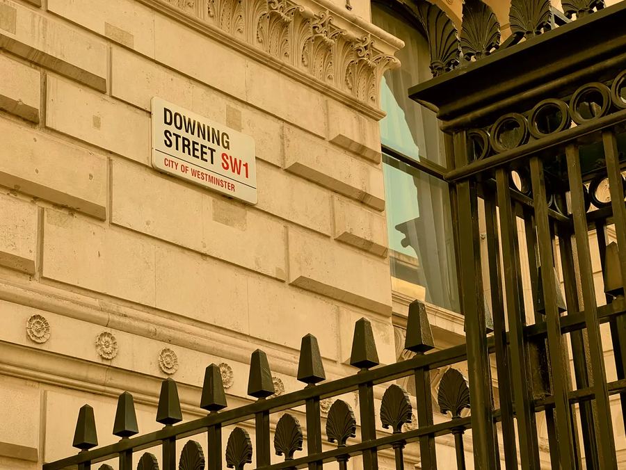 The Downing Street SW1 street sign, City of Westminster, beside black railings